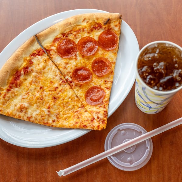 Two slices of NY Pizza Patrol pizza, one cheese and one pepperoni, with a soda.
